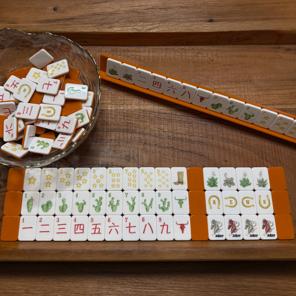Copper Spurs travel mahjong set with orange racks and western-inspired tiles