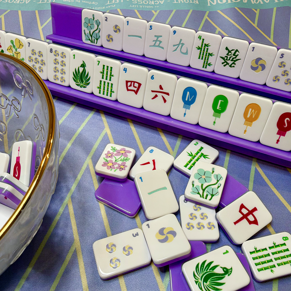 Lavender Jade travel mahjong set featuring purple racks, colorful acrylic tiles, and a coordinating lavender mahjong mat.